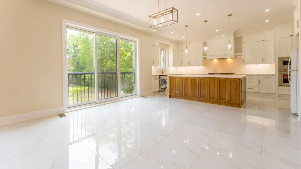 Open-concept living area with tile and hardwood flooring in a GrandBuild custom home