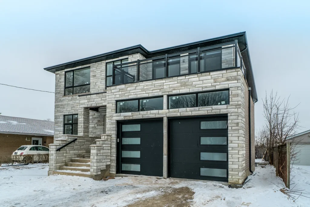 Front elevation of a modern stone custom home at 3114 Bonaventure