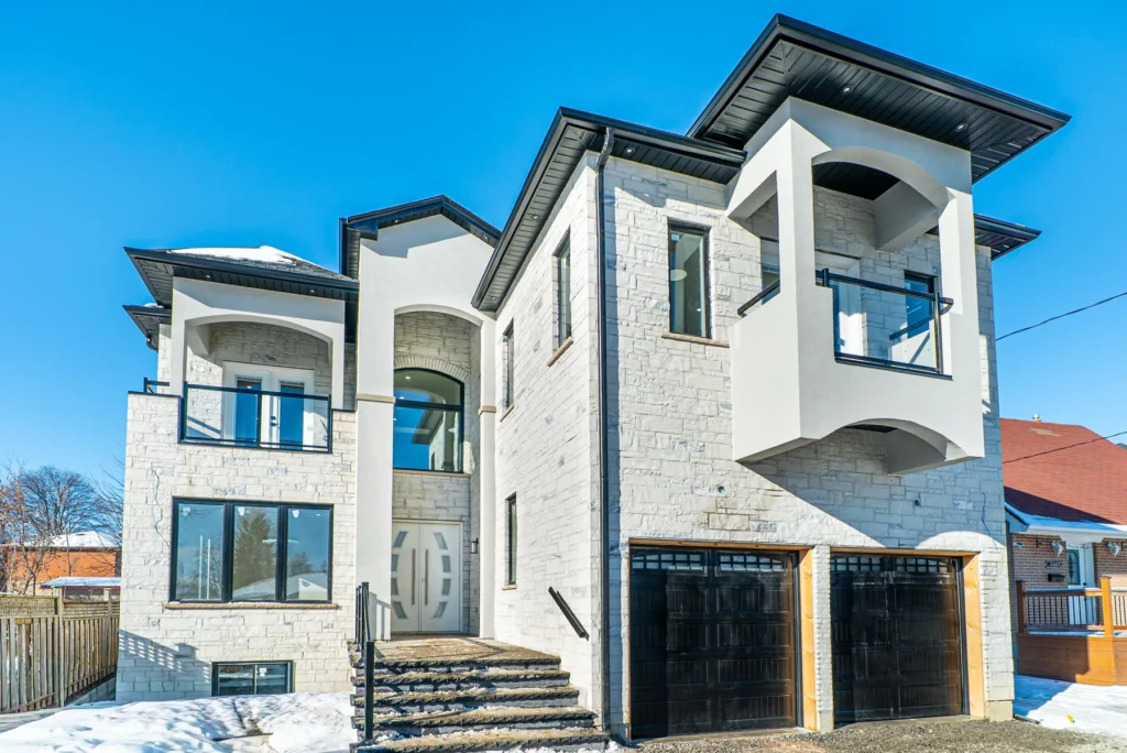 White stone front elevation of a custom home on Michaud